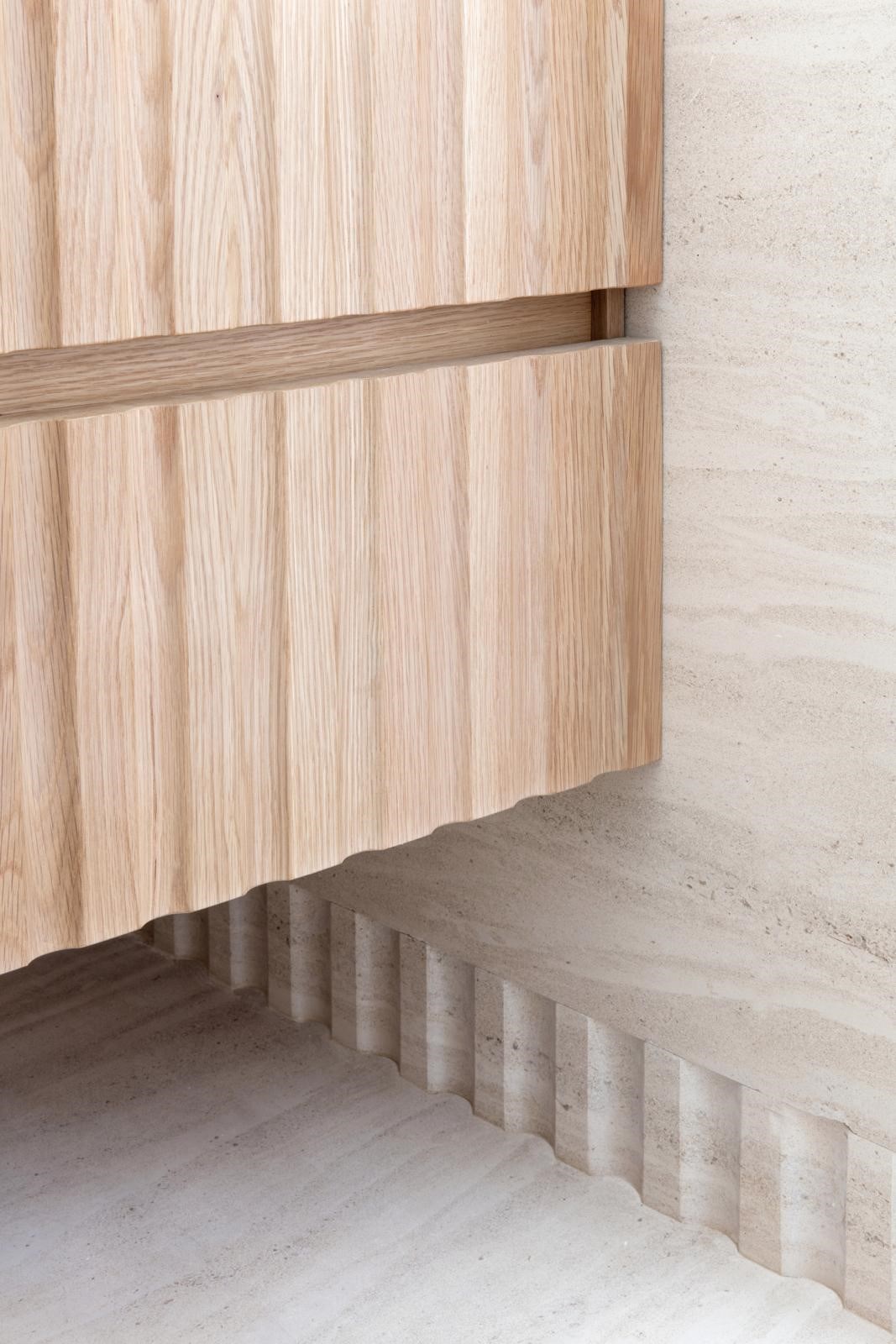 Mont Doré limestone ribbed baseboard detail matching with ribbed oak vanity